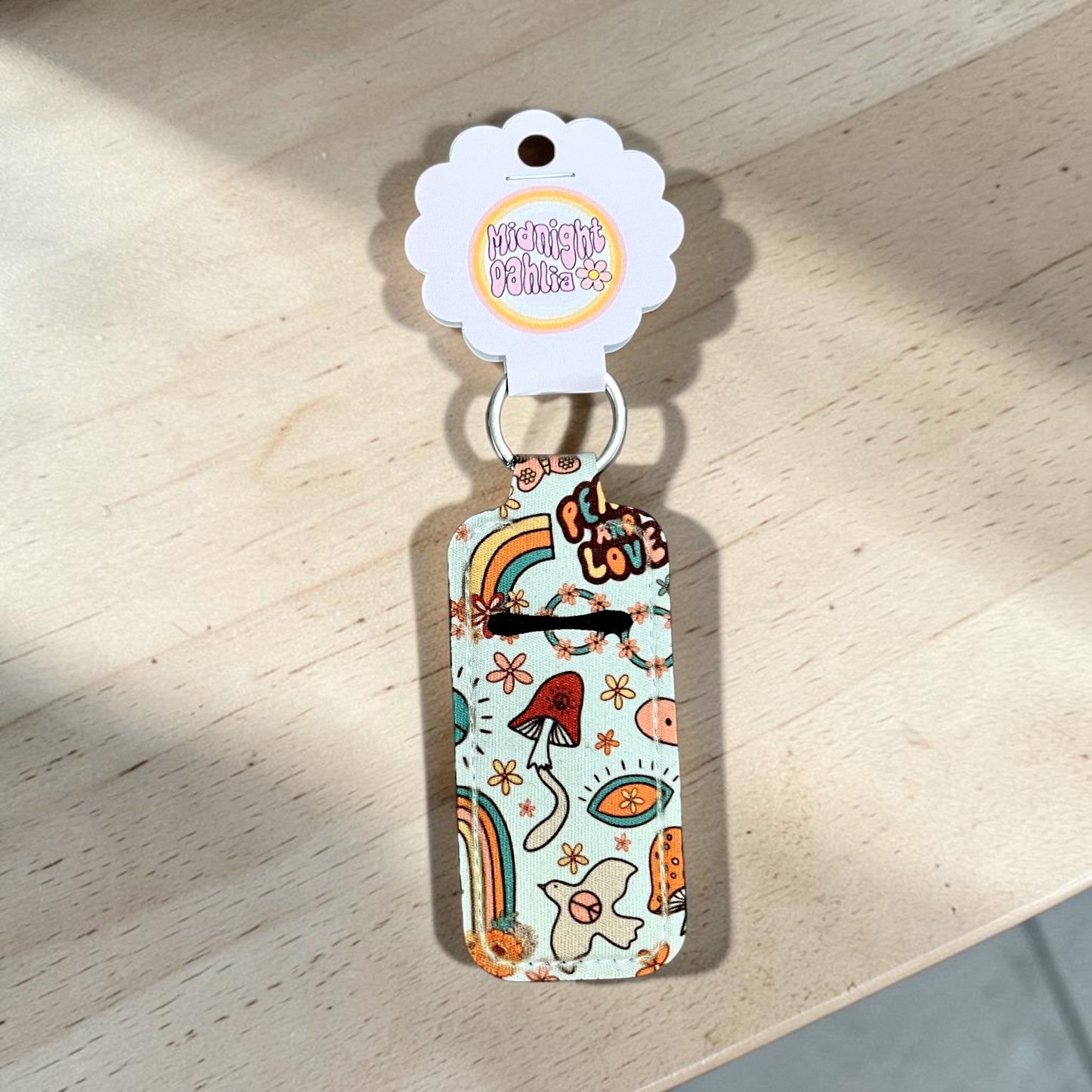 Colorful keychain with cartoon designs on a wooden surface