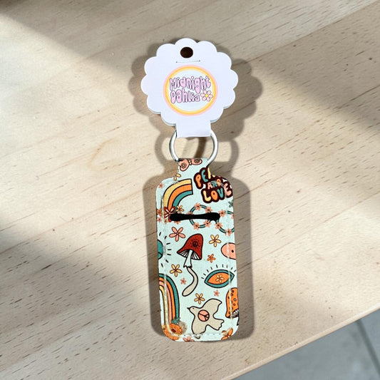 Colorful keychain with cartoon designs on a wooden surface