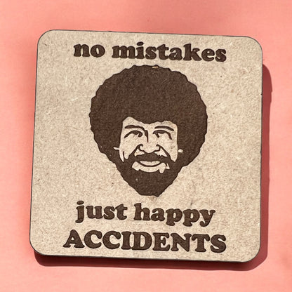 A square magnet with a humorous quote printed on it, placed against a pink background.