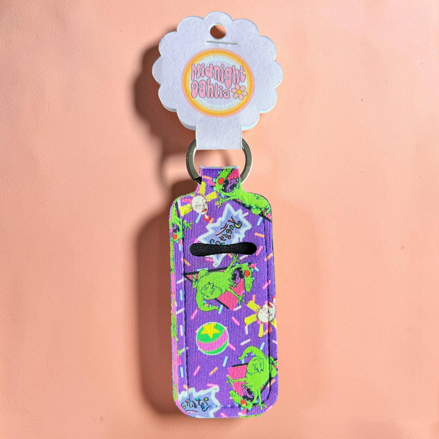 Colorful keychain with cartoon characters on a pink background