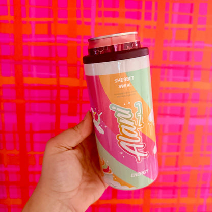 Hand holding a pink energy drink can with colorful design against a bright pink and orange checkered background