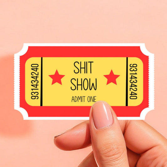 a ticket shaped sticker in red and yellow that reads shit show admit one