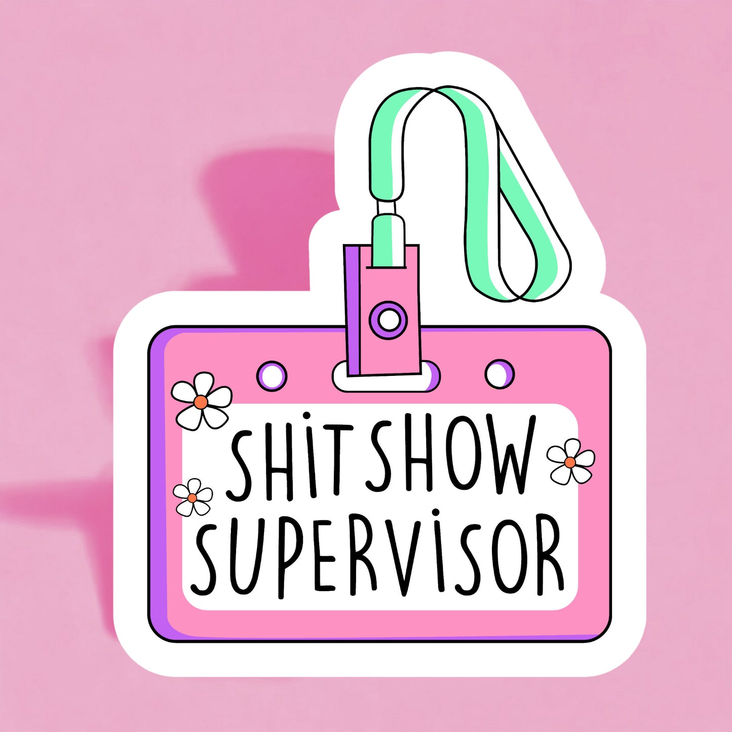 A colorful sticker with a name tag that reads 'SHIT SHOW SUPERVISOR' on a pink background, adorned with illustrations of flowers and a lanyard.