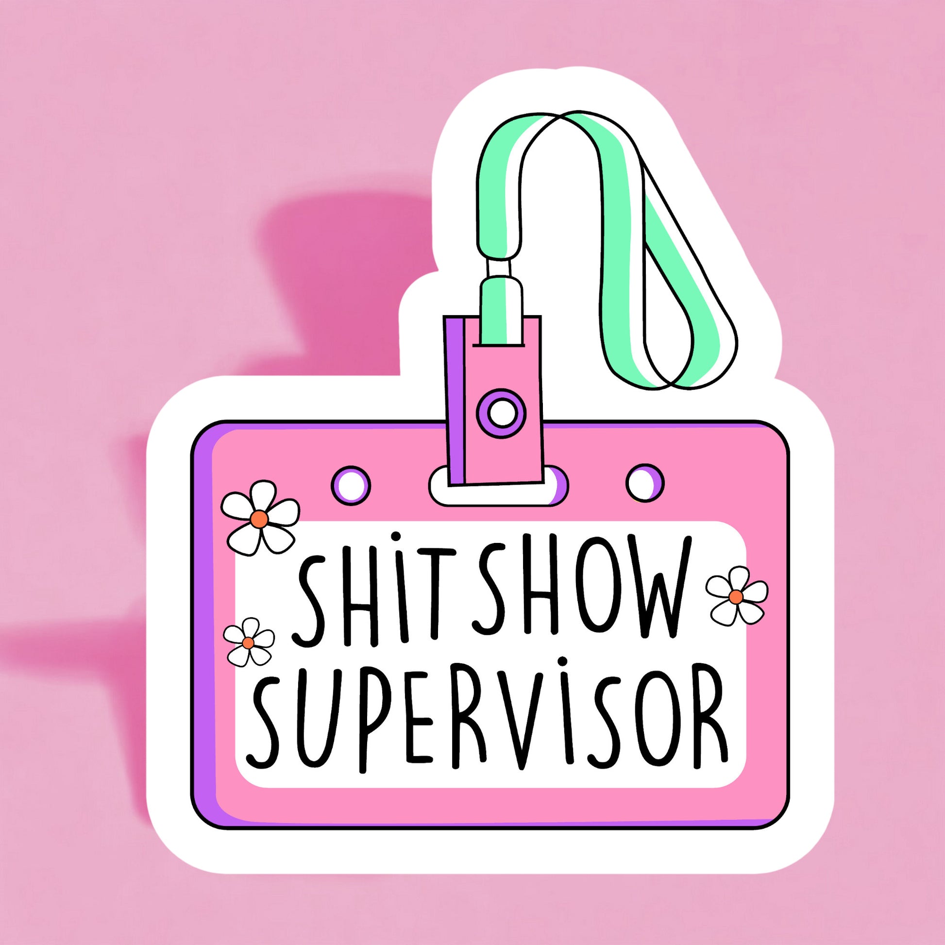 A colorful sticker with a name tag that reads 'SHIT SHOW SUPERVISOR' on a pink background, adorned with illustrations of flowers and a lanyard.