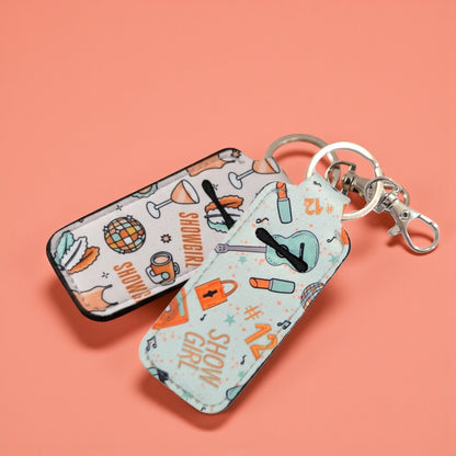 Two small rectangular cases with colorful designs on a pink background