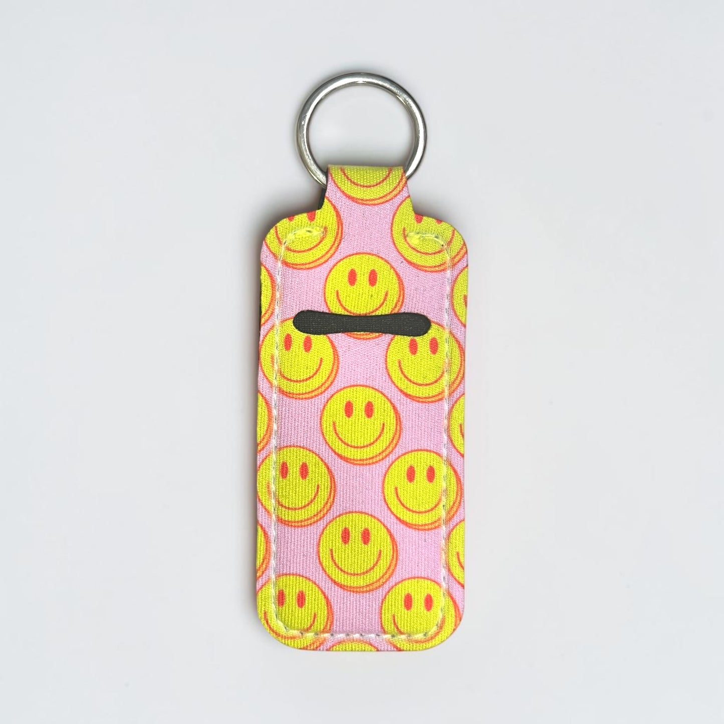 Keychain with smiley face pattern on a pink background