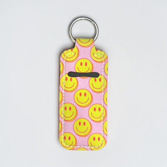 Keychain with smiley face pattern on a pink background