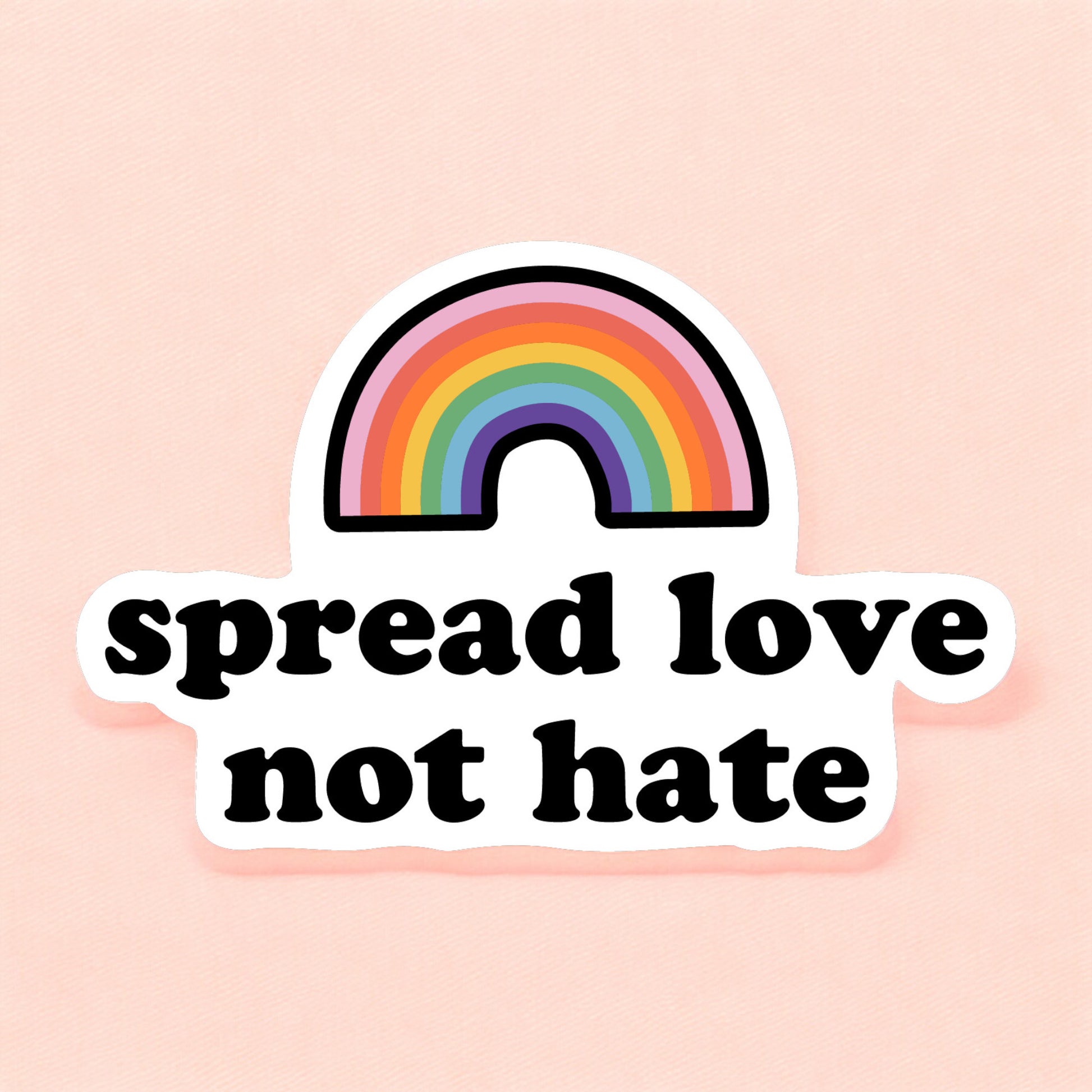 a pride sticker that reads spread love not hate with a rainbow
