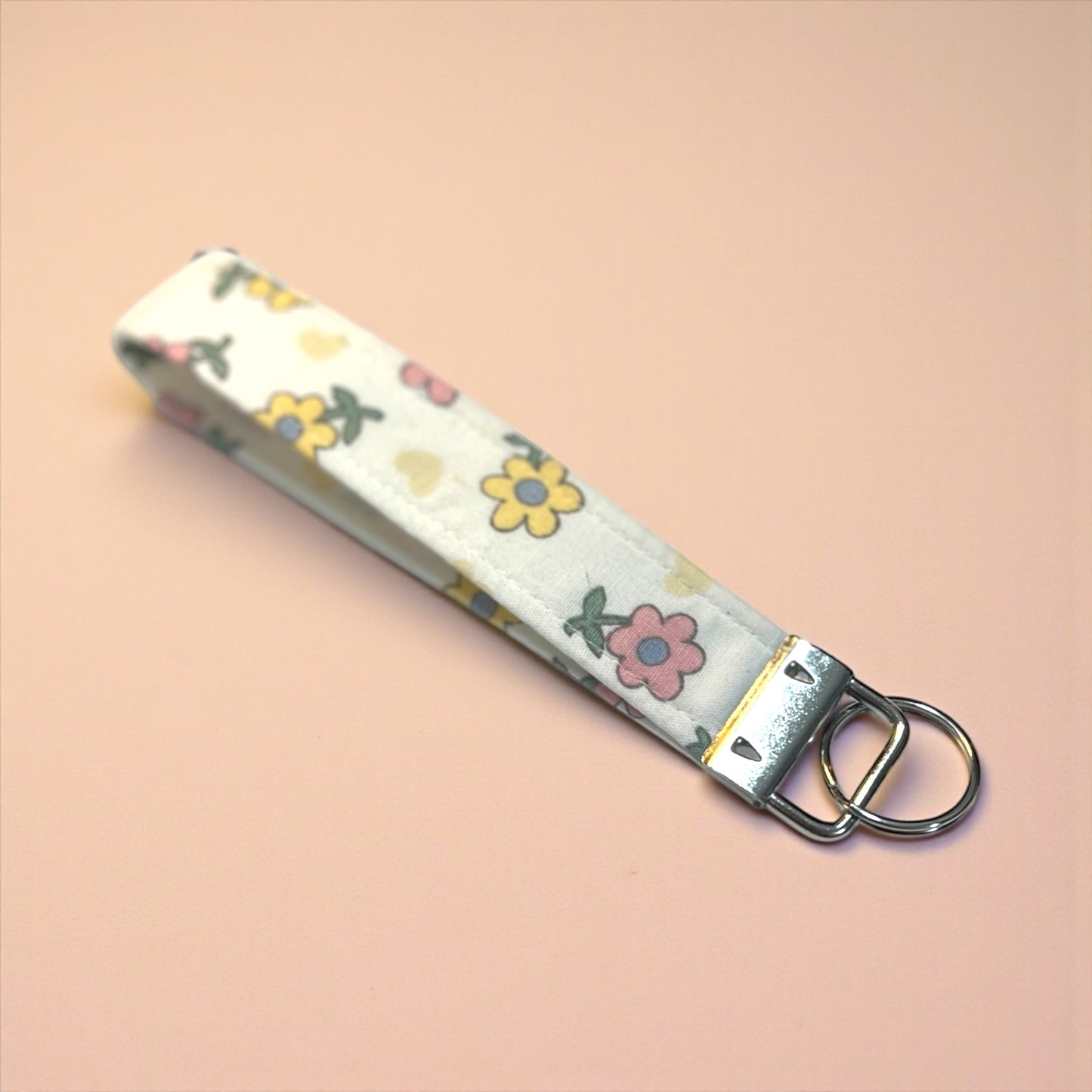 Floral patterned keychain on a beige background