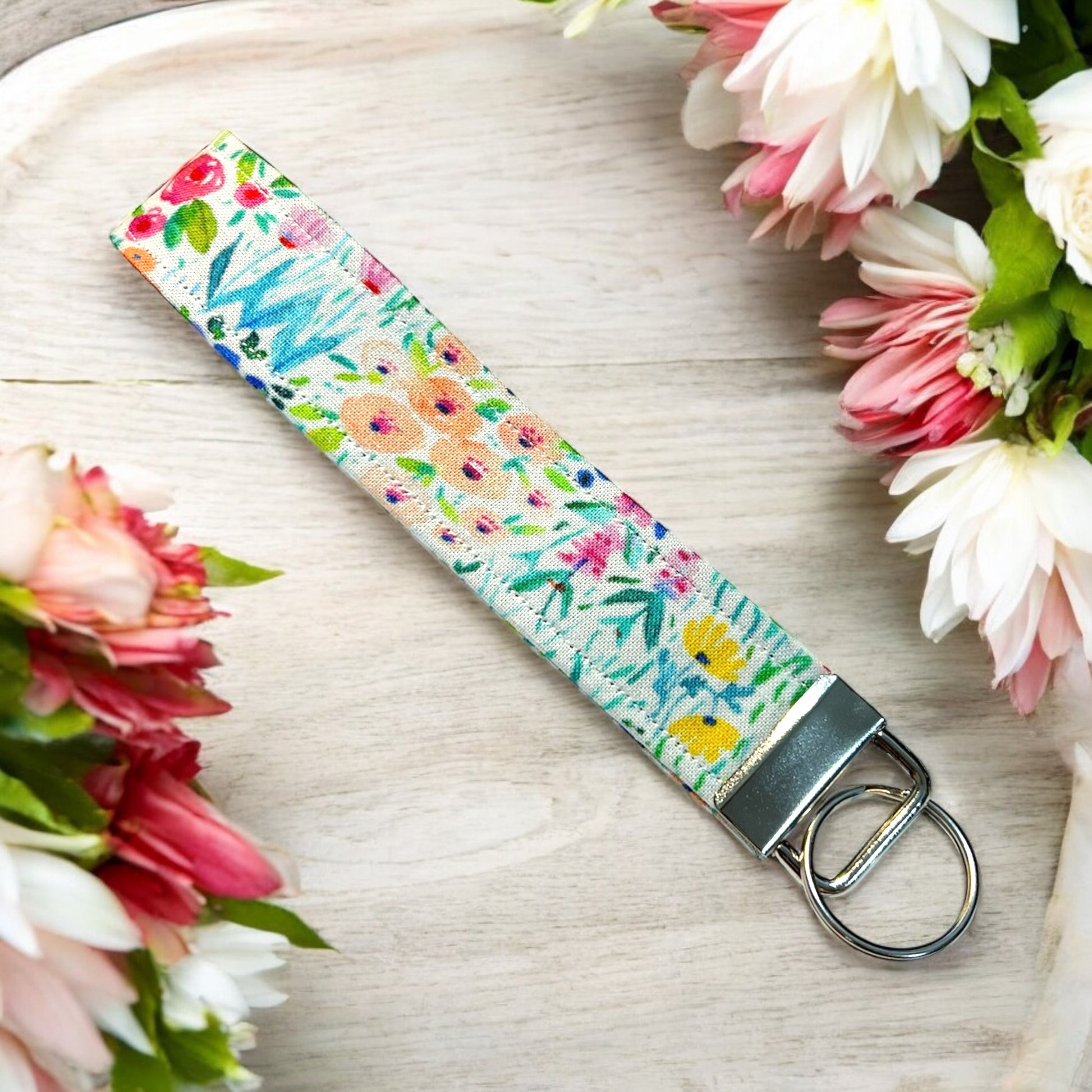 a handmade fabric wristlet keychain key chain against a pastel background