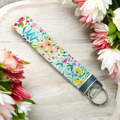 a handmade fabric wristlet keychain key chain against a pastel background