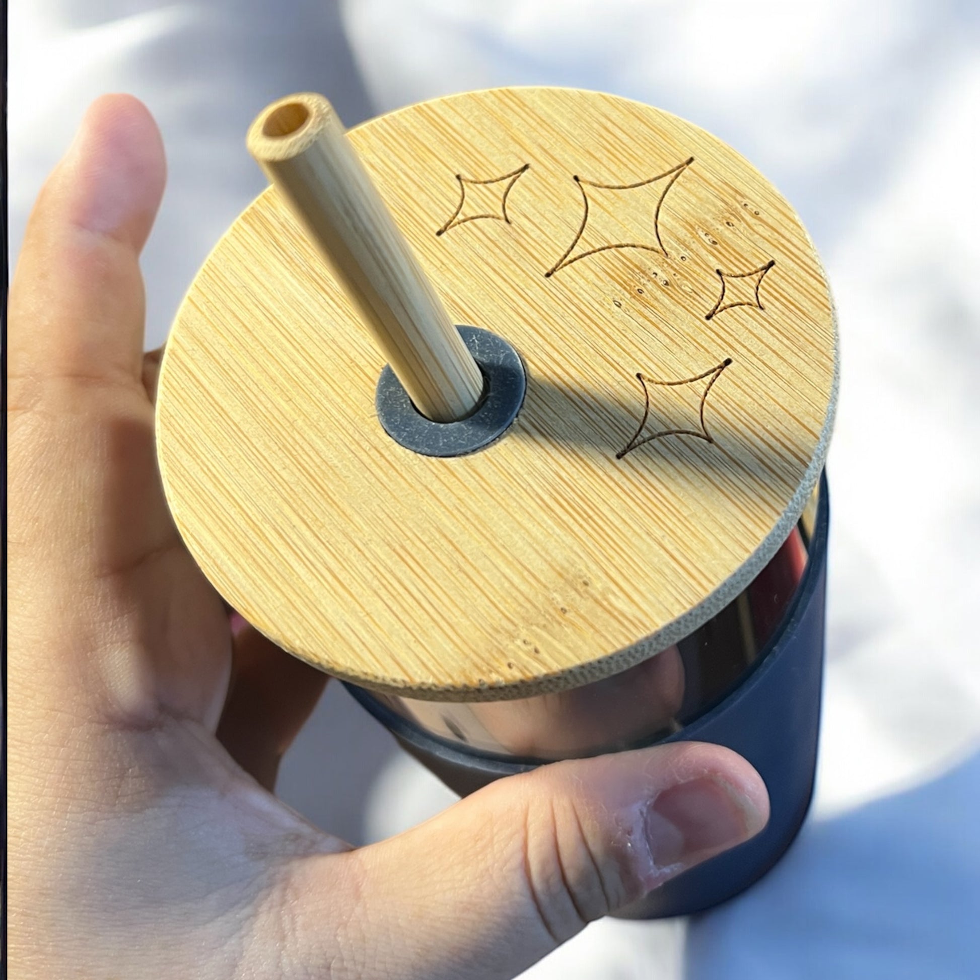 a bamboo tumbler lid engraved with stars