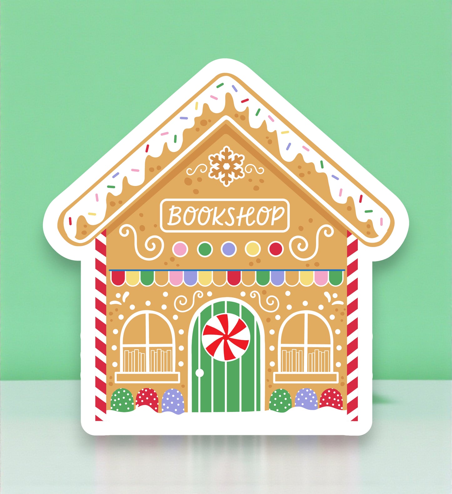 Gingerbread house-shaped bookshop sign with colorful details on a light green background