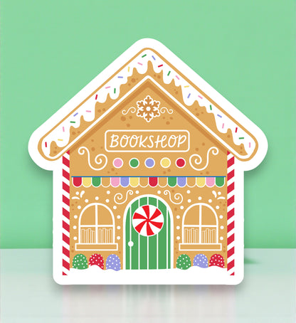 Gingerbread house-shaped bookshop sign with colorful details on a light green background