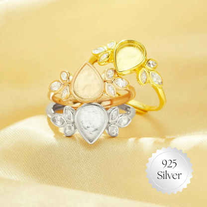 Two gold rings with a heart design on a yellow background, featuring '925 Silver' stamp.