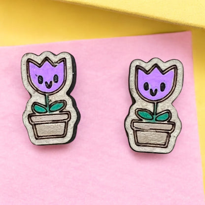 Pair of tulip-shaped earrings on a pink background