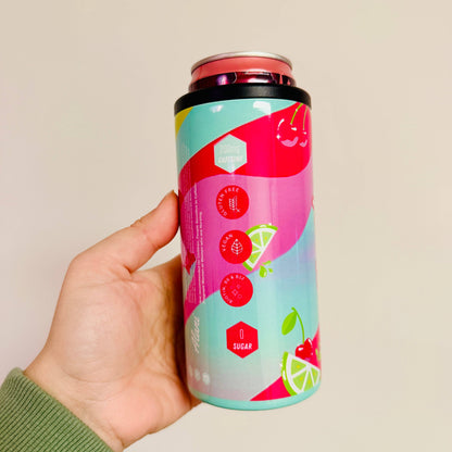 Hand holding a colorful can with a brand logo against a beige background