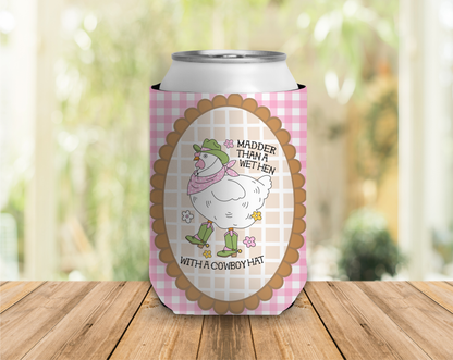 Can cooler with cartoon chicken design and text on a wooden surface with a blurred natural background