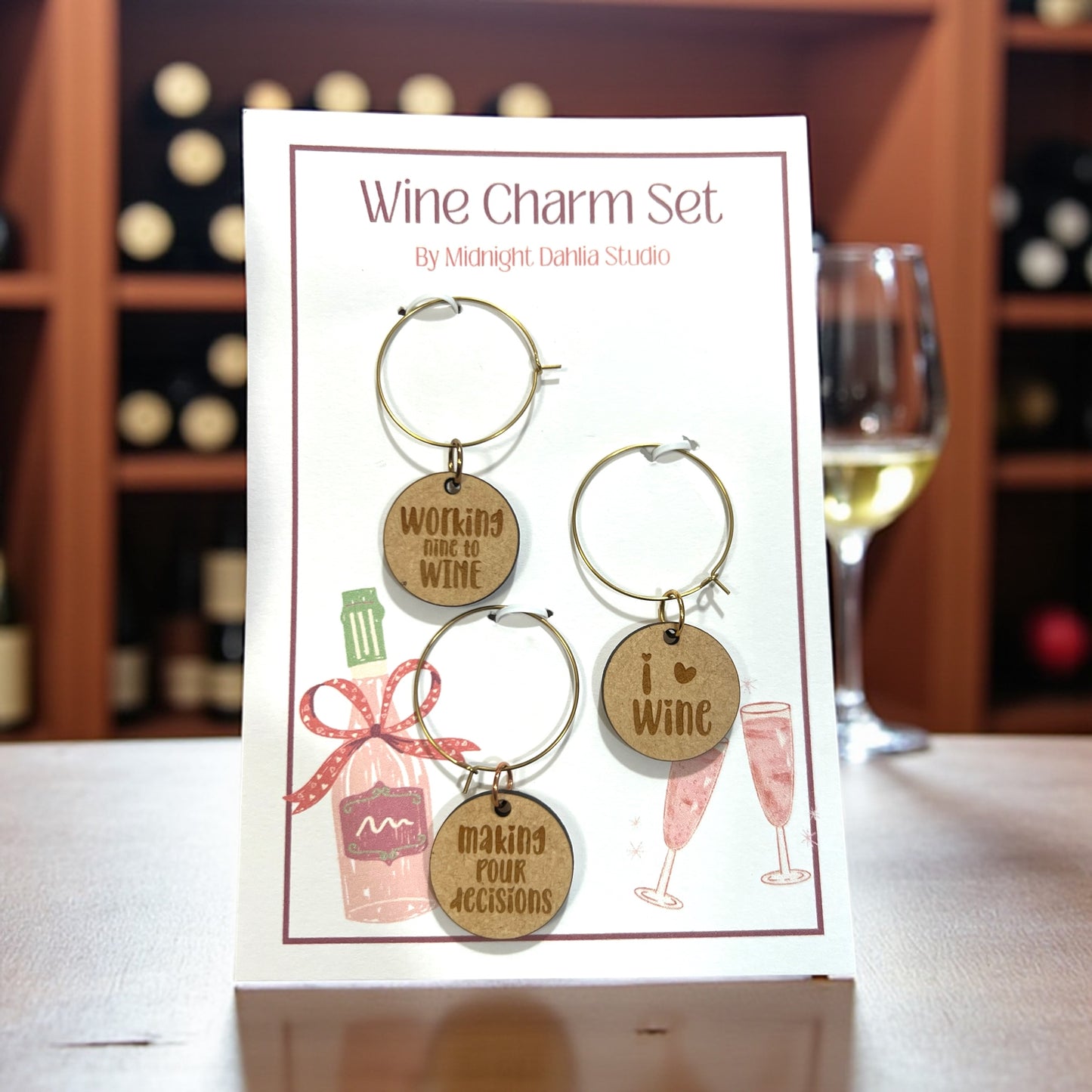 Wine charm set on a card with wine bottles and glasses in the background