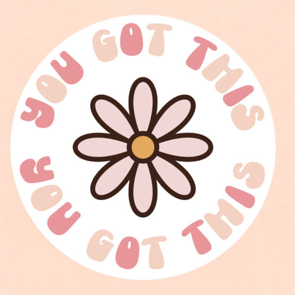A round white sticker that reads you got this surrounding a pink daisy