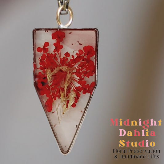A custom resin necklace with pressed red queen annes lace flower.  Beautiful add-on for a bridal bouquet preservation.
