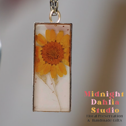 A custom resin necklace with pressed yellow daisy flower.  Beautiful add-on for a bridal bouquet preservation.